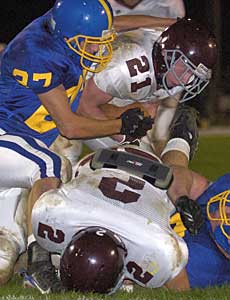 Salem High School's Jonathan Clemo (21) breaks away from a tackle by Robert Sterrett and powers his way to the end zone for the Spartan's first TD of the game during first quarter  at Blacksburg High School.